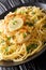 Chicken FrancaiseÂ or Chicken Francese is an Italian-American dish served with spaghetti with lemon sauce close-up on a plate.